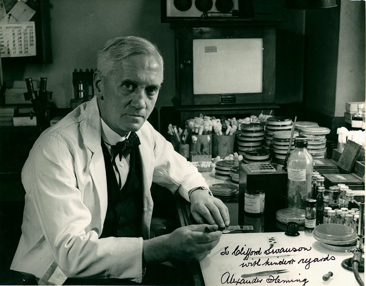 Robert Koch, who proved that particular bacteria cause particular diseases and invented the methods for growing them (Wellcome Collection, CC BY 4.0). Right: Alexander Fleming in his laboratory with plates of the mould whose product became penicillin (U.S. Navy archive, public domain).