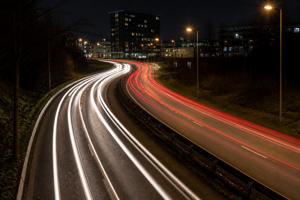 A camera left open at night draws trajectories: every headlamp traces the exact path its car followed.