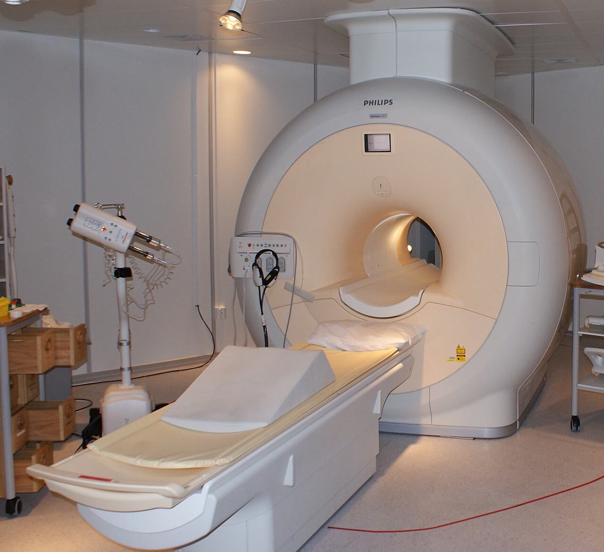 An MRI scanner: a superconducting solenoid holding 1.5\, T over a patient — a megajoule of magnetic energy in a field with nothing in it. Photograph: Jan Ainali, CC BY 3.0.